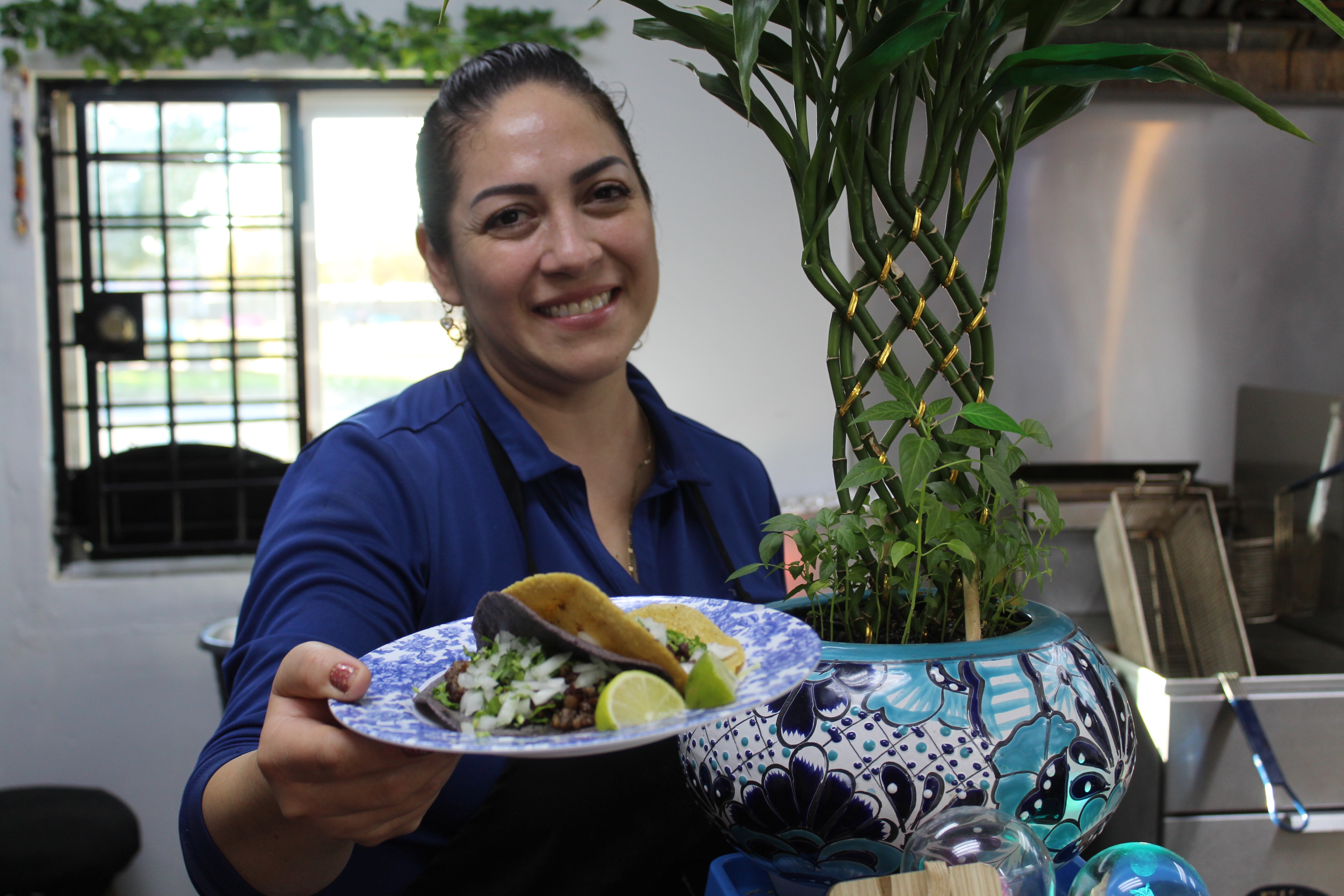 woman holding out taco plate